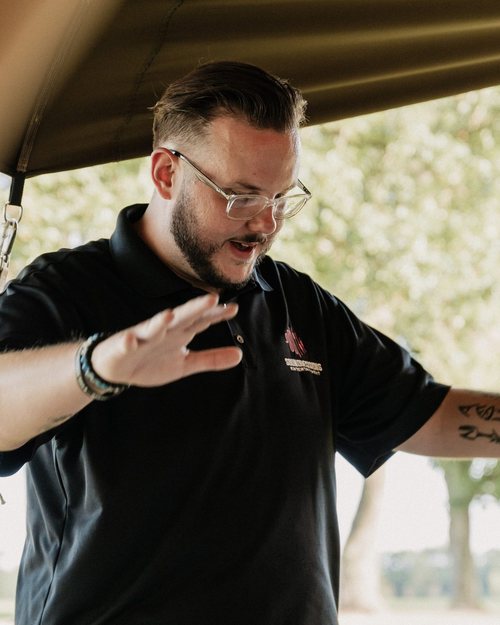 Mike Sanders on the mic at an outdoor event